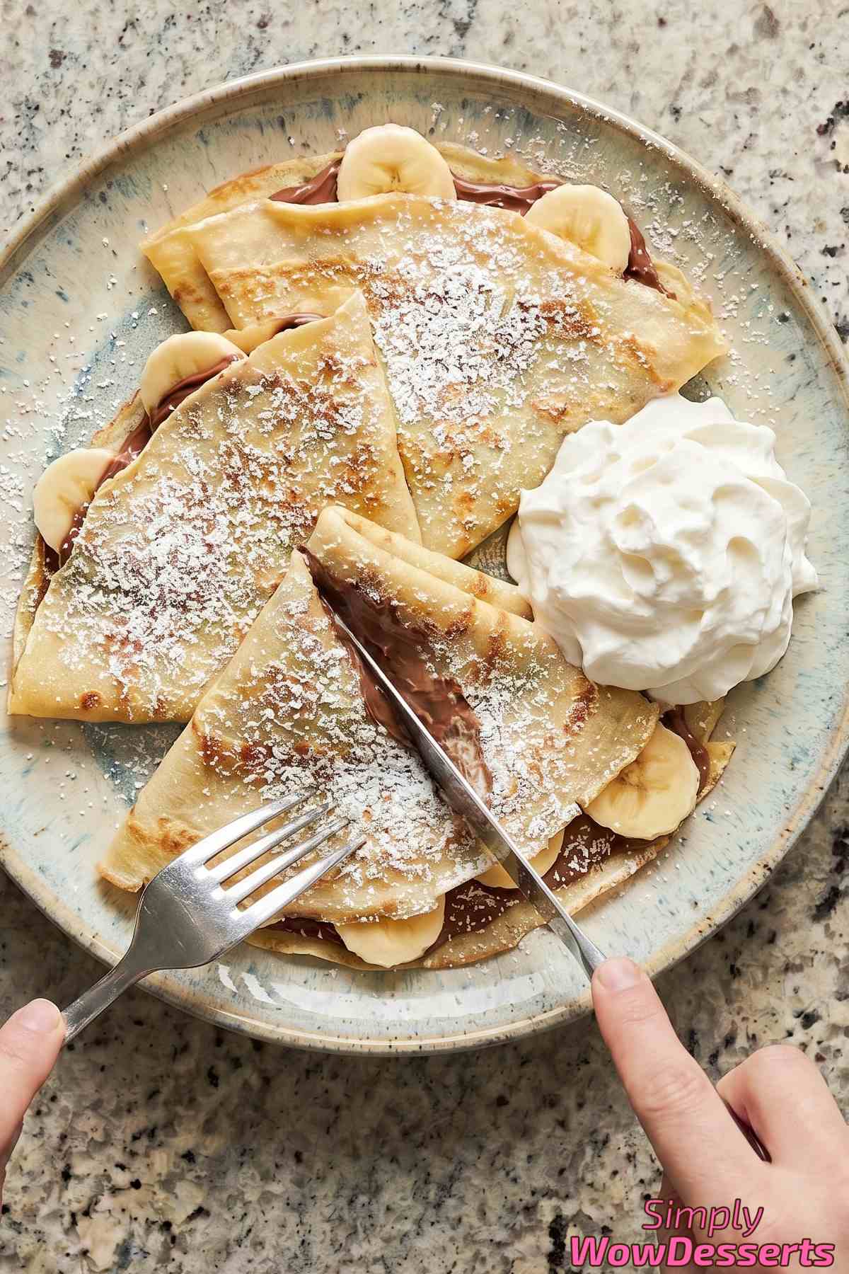 Homemade Nutella banana crepes with powdered sugar