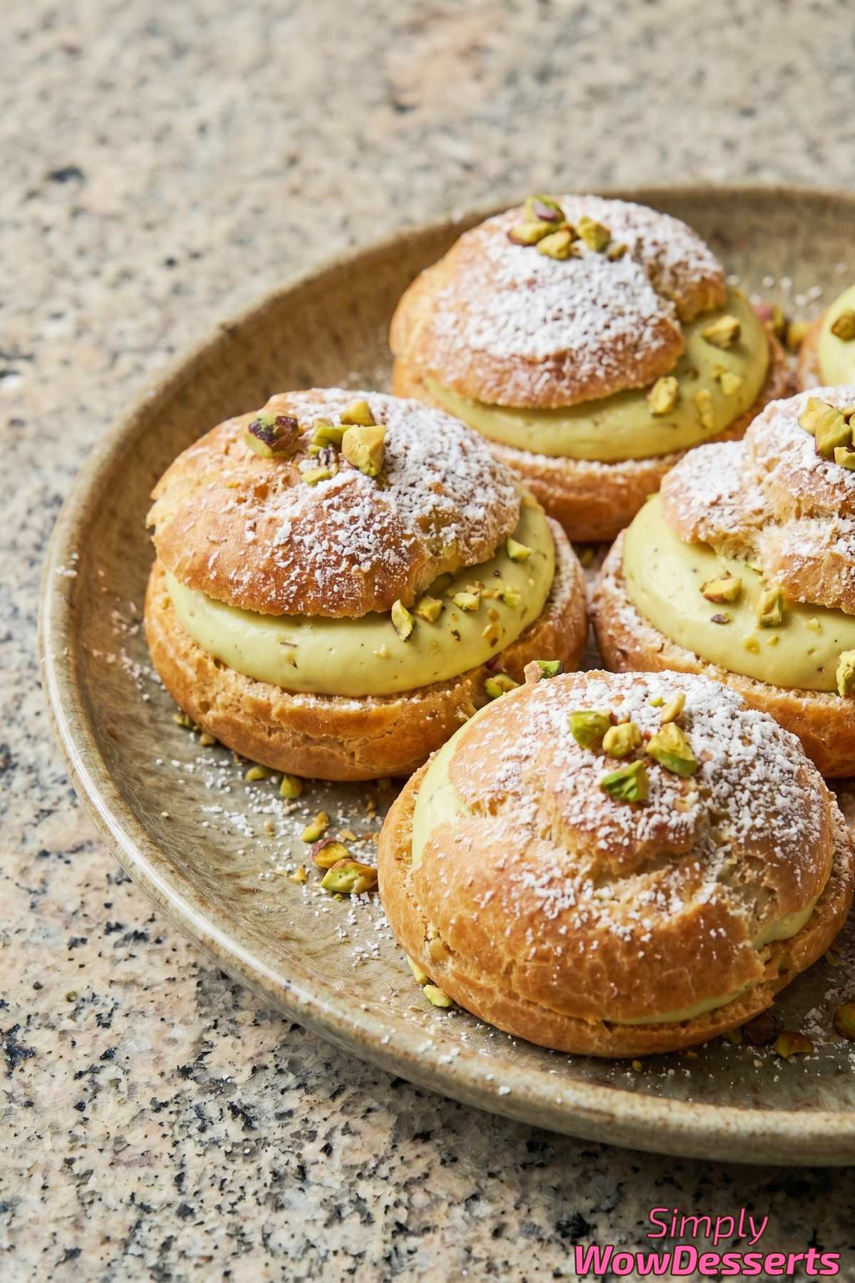Bite-sized pistachio cream puffs stacked high