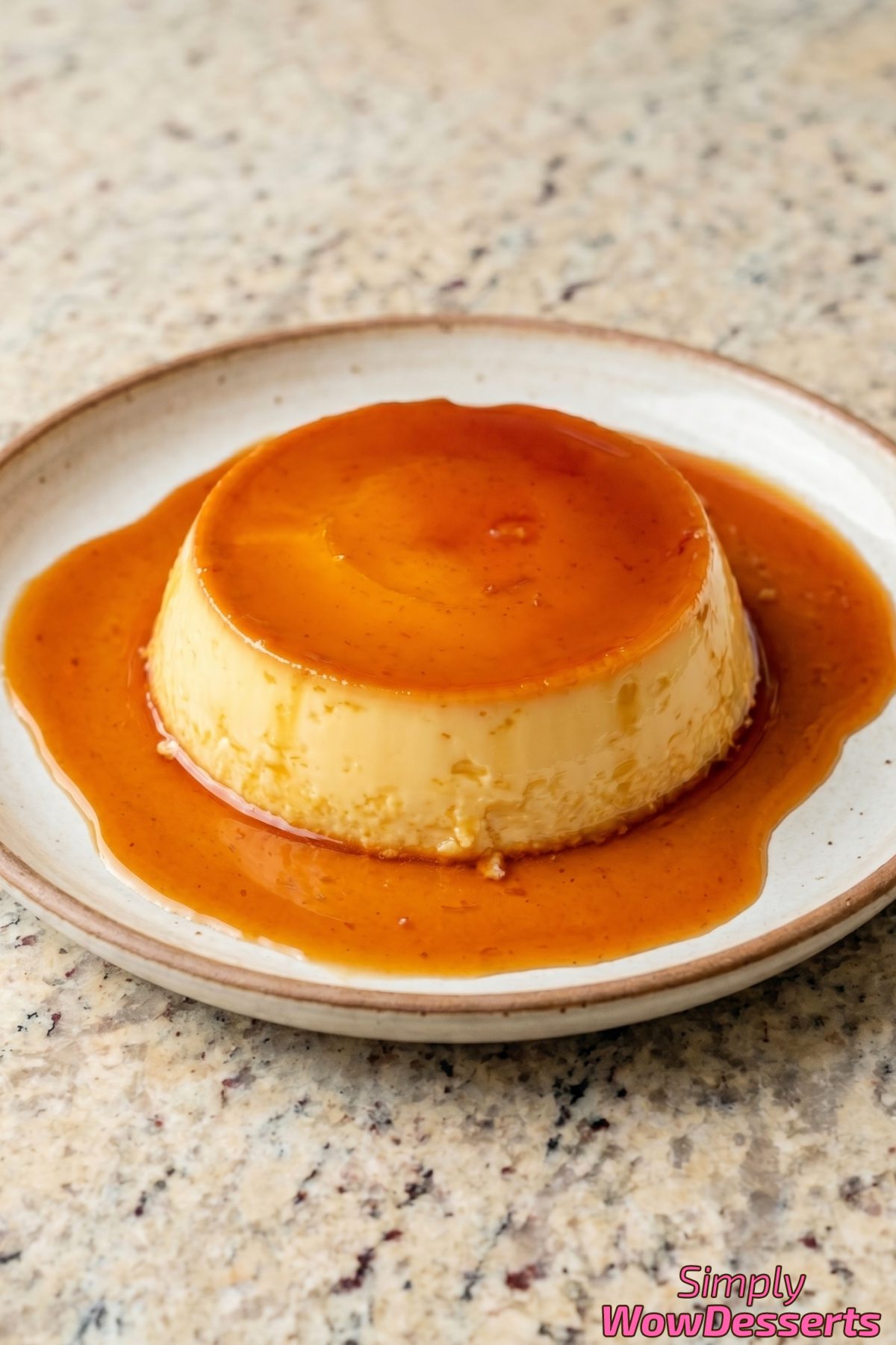 Luscious caramel flan on white dish